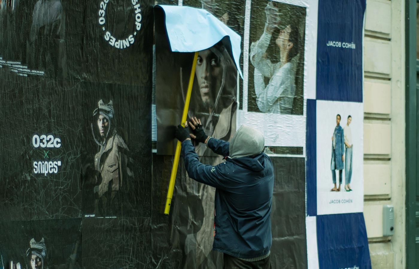 Wheatpaste poster installation by street teams in Los Angeles